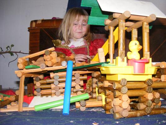 Sarah with our crazy Lincoln Log house.