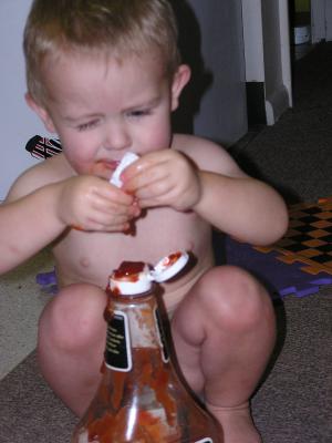 Noah found some ketchup packets. 
He thinks they should go into the ketchup bottel. 
Here are his attempts to ge them in there.