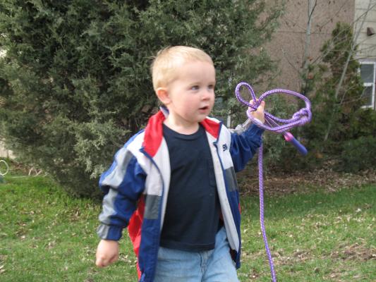 Noah plays with a purple jumprope.