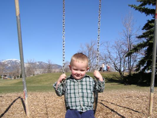 Noah swings at the park.