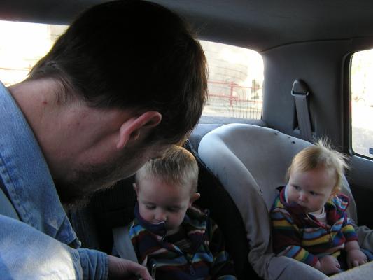 David adjusts Noah's car seat.