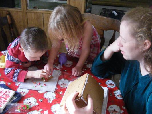 Noah and Sarah decorate a gingerbread house