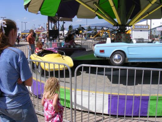 Katie and Sarah watch Noah drive.