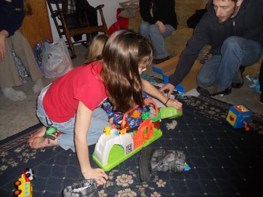 Andrea helps Joshua get his zoo together. 