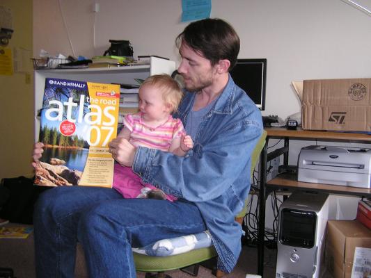 Sarah and David unwrap the birthday gift. It's an atlas!
