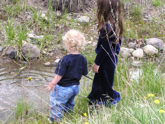 Andrea and Noah play in the water.