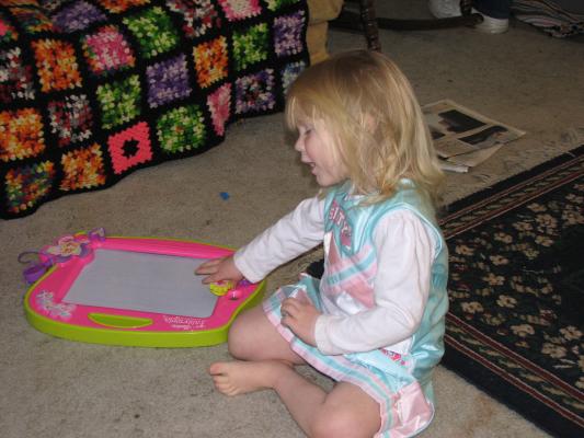 Sarah in her new birthday outfit, playing with a new toy.
