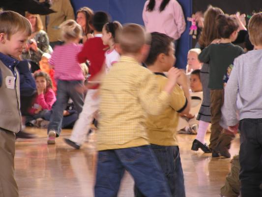 Andrea singing with other kindergarten and first graders.