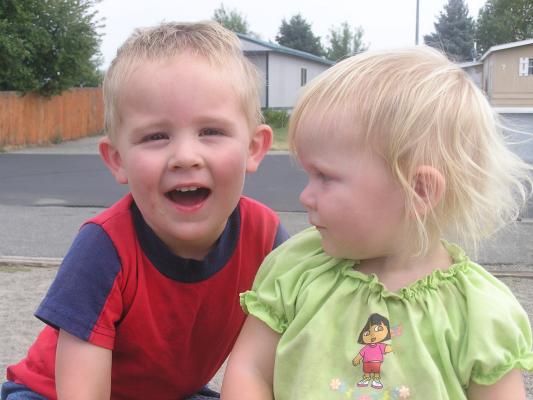Noah and Sarah on a tire at the park.