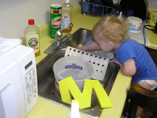 Noah plays in the sink.