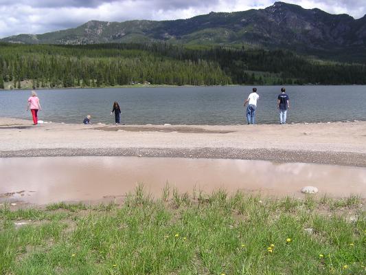 The kids play at the edge of the lake.