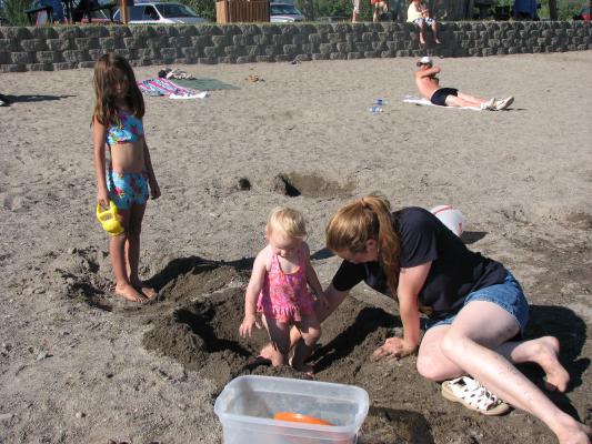 Andrea, Sarah adn Katie play in the sand
