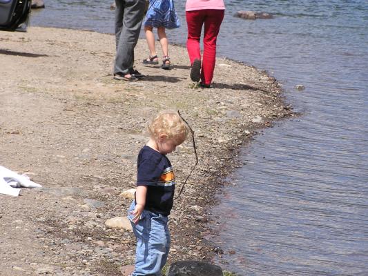 Noah plays at the water's edge.