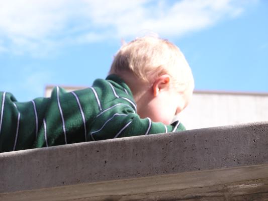 Noah climbs the wall.