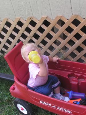 Sarah plays in the wagon.