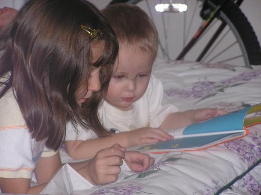 Andrea and Noah read a book together.