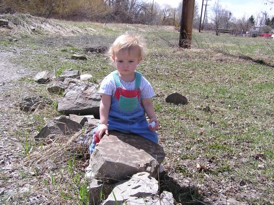 Noah climbs on the rocks.