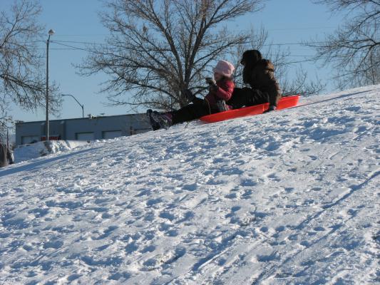Andrea and Malia sledding.
