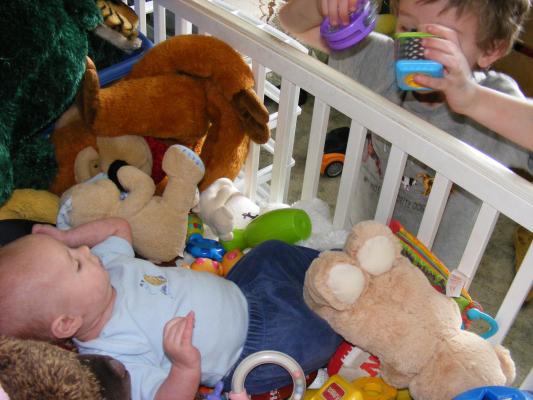 Noah got all the baby toys for Joshua to play with.