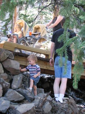 Noah and David play on some rocks by the bridge