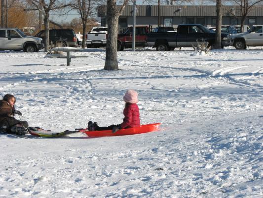 Malia and Andrea sledding.