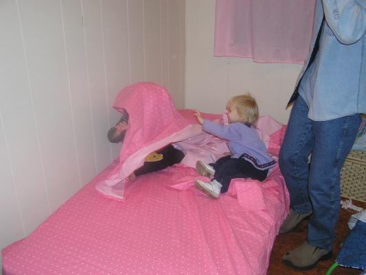 Noah and Sarah play with Sarah's new sheets.