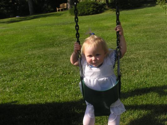 Sarah swinging in her pretty dress.
