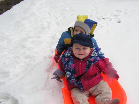 Noah and Sarah in a sled.