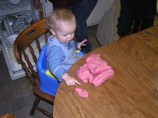 Noah plays with play-dough at his Great Grandpa's