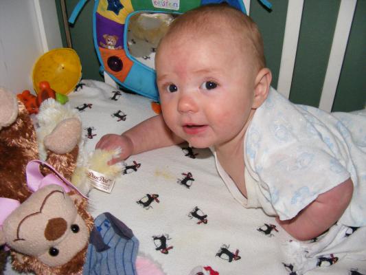 Joshua plays in his crib