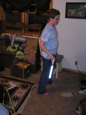Joe swings the light saber.