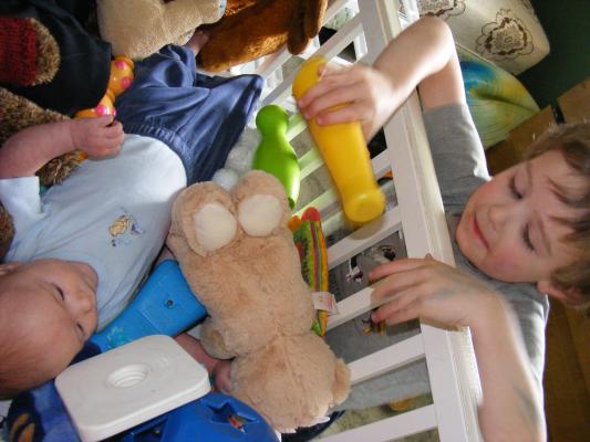 Noah got all the baby toys for Joshua to play with.