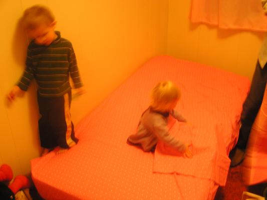 Noah and Sarah play on the new bed