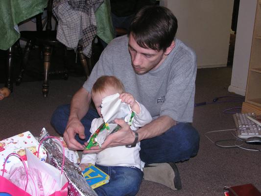 Sarah tears some wrapping paper.
(It's Christmas Santa Claus paper)