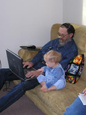 Noah helps grandpa play video games.
