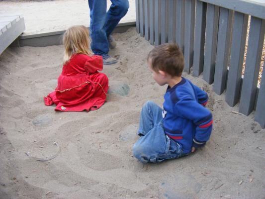 Sarah and Noah play in the sand.