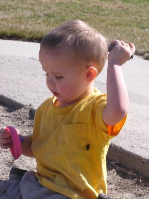 Noah plays in the sand.