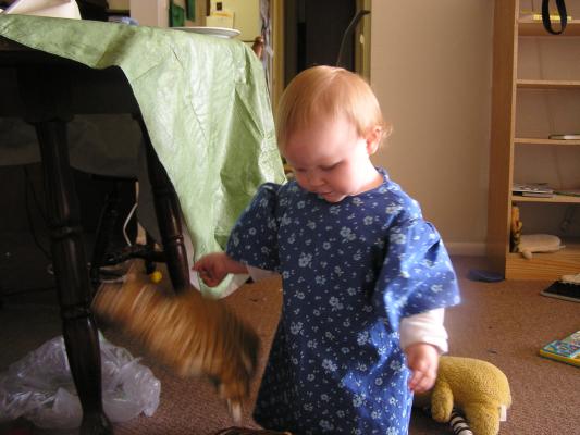 Sarah throws a toy cat out of the basket.