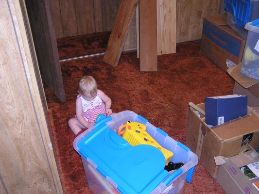 Sarah plays toys in the new trailer home
