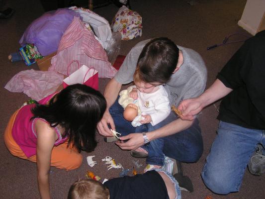 Sarah plays with her baby, David plays with an animal.