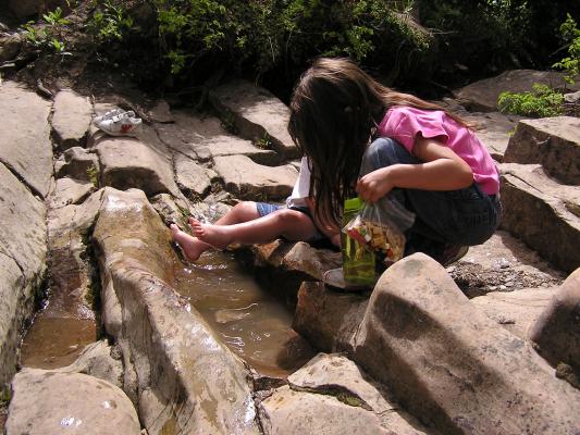 Andrea and Noah play in the little puddles.
