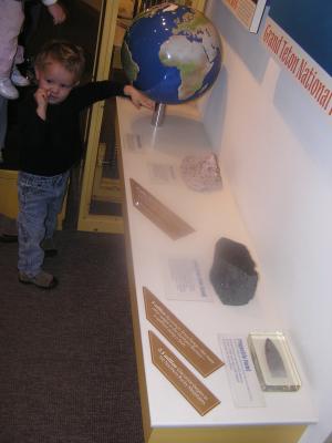 Noah looks at a globe at the Museum of the Rockies.