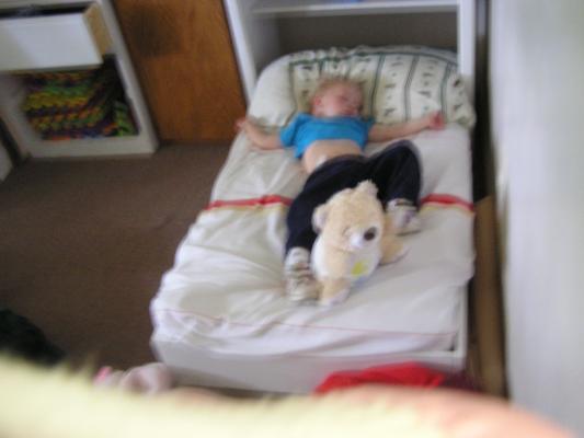 Noah sleeps in his bed.