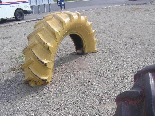 Noah in a tire at the park.