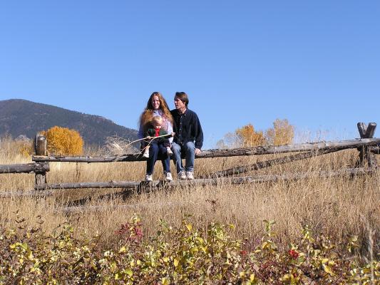 Family portrait on the fence with the M in the background.