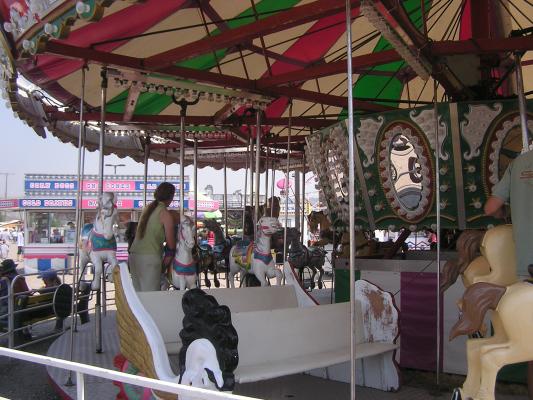 Katie helps Sarah on the carousel.