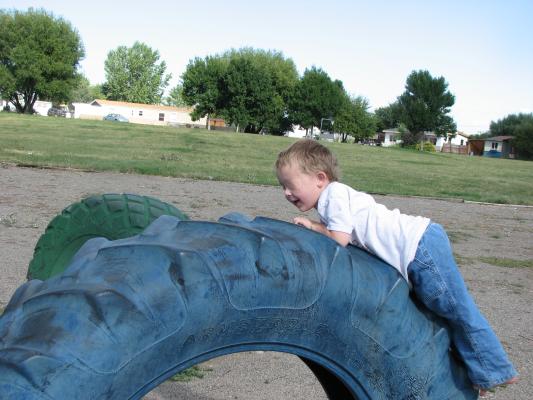 Noah and Sarah at the park in Covered Wagon Mobil home park. Play on Tires