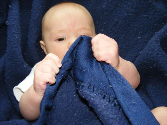 Joshua in a blue blanket.