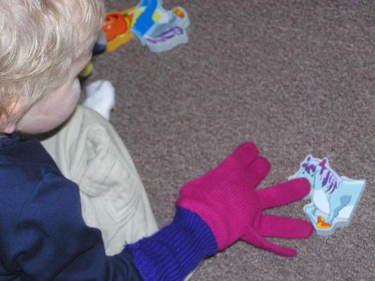 Noah plays wiht magnetic animals.
