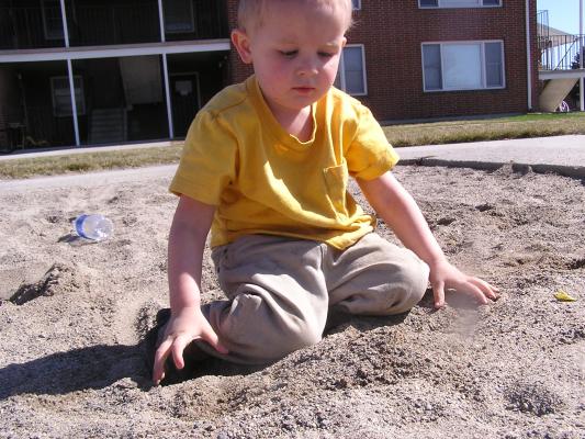 Noah plays in the sand.